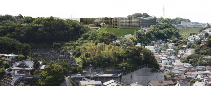 建設地現況にマンション完成予想図を埋め込んだもの。開発にあたっては敷地内に道路を新設。近隣の小学校の敷地拡大や、駅からのアプローチにある歩行者用トンネルの改良も行ない、居住者と近隣住民の利便性を向上させる