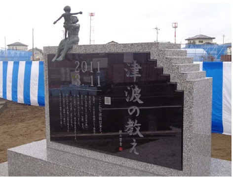 「津波の教え石」。石碑の上には、静岡市の彫刻家、大塚亮治氏が制作した命の大切さや親子の絆などを伝える母子像「伝え行くもの」を配置