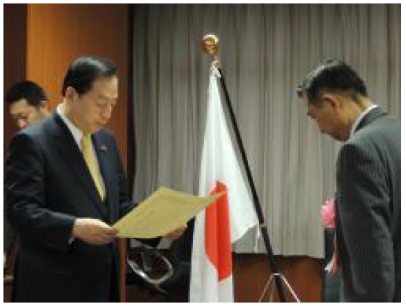 太田昭宏国土交通大臣から表彰を受ける様子。写真右はイオンモール(株)取締役会長の村上教行氏